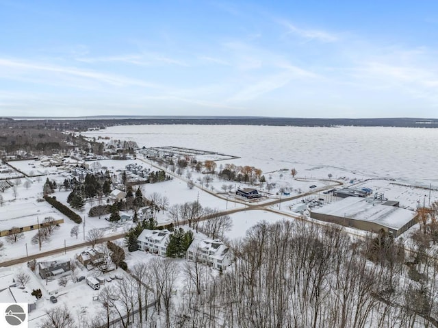 snowy aerial view featuring a water view