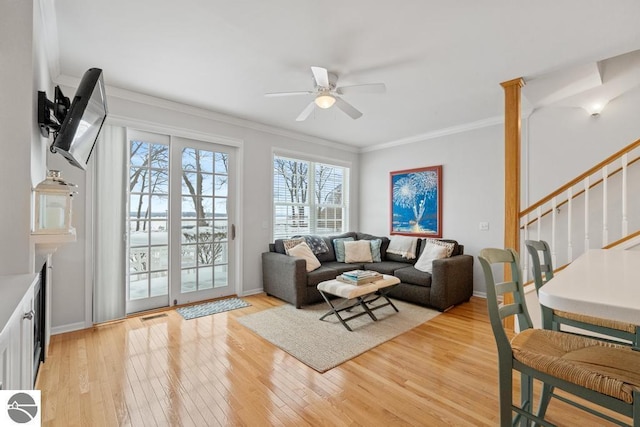 living room featuring crown molding, ceiling fan, and light hardwood / wood-style floors