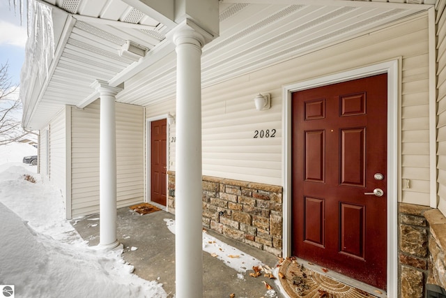 view of snow covered property entrance