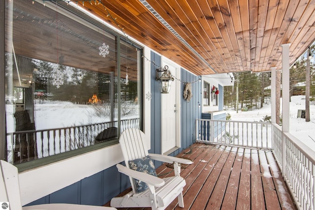 snow covered deck with covered porch