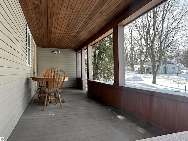 unfurnished sunroom with wood ceiling