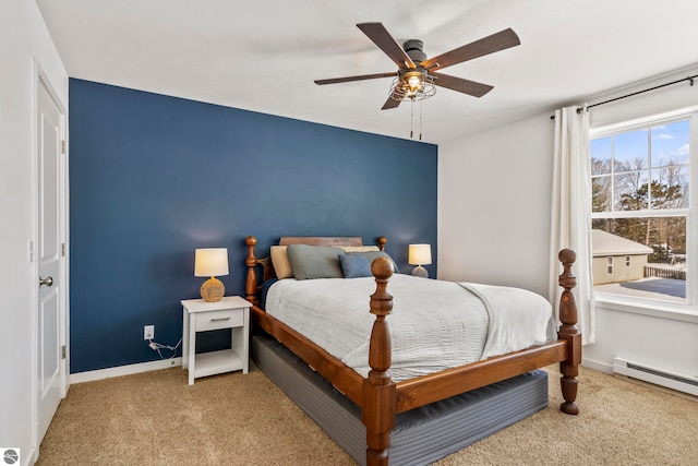 carpeted bedroom featuring a baseboard radiator and ceiling fan