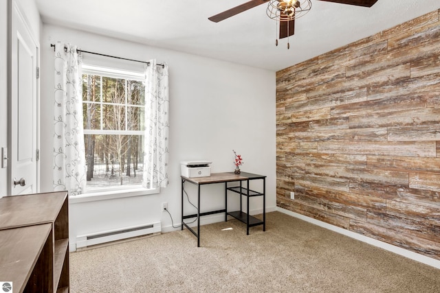 interior space with a baseboard heating unit, carpet floors, ceiling fan, and wood walls