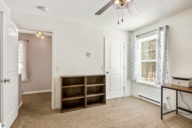 carpeted home office featuring baseboard heating and ceiling fan