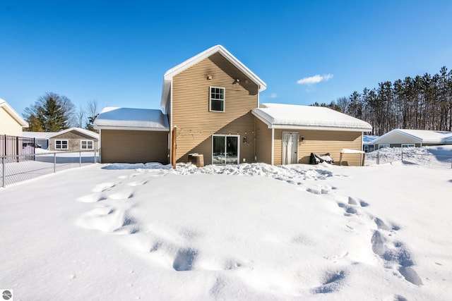 view of snow covered rear of property