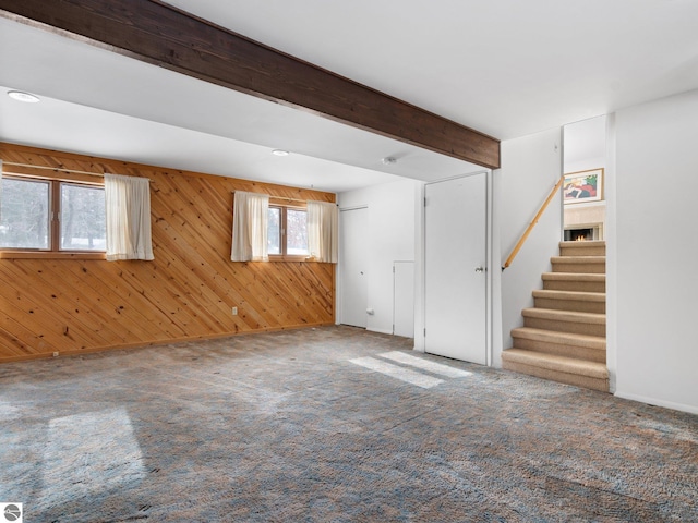 basement with wood walls and carpet flooring