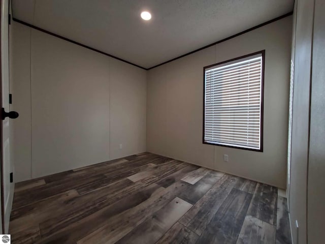 unfurnished room with crown molding and dark hardwood / wood-style floors