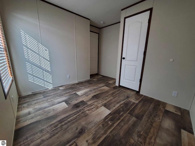 unfurnished room with dark wood-type flooring