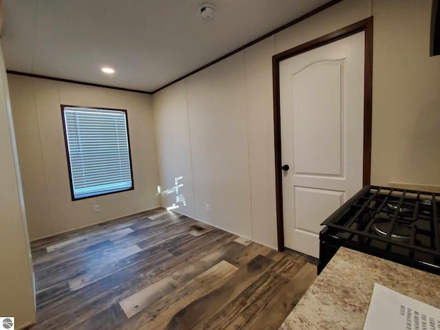 interior space with ornamental molding and dark hardwood / wood-style floors