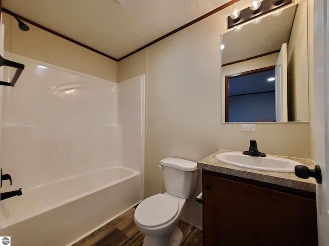full bathroom featuring toilet, bathing tub / shower combination, crown molding, vanity, and hardwood / wood-style floors