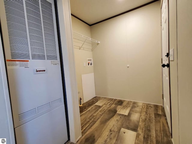 washroom with hardwood / wood-style flooring, crown molding, and hookup for a washing machine