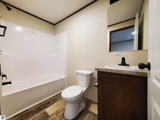 full bathroom featuring shower / tub combination, vanity, hardwood / wood-style floors, and toilet