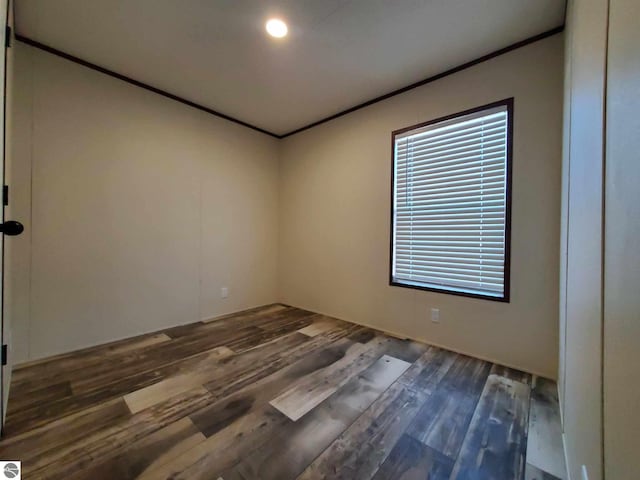 unfurnished room featuring crown molding and dark hardwood / wood-style floors