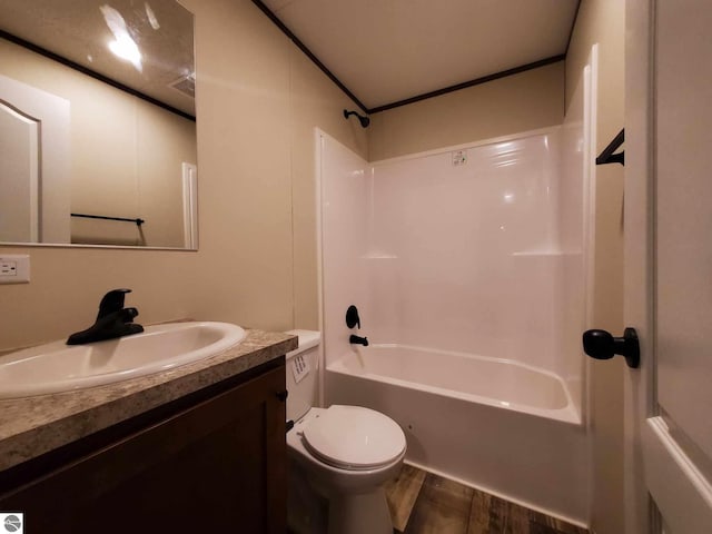 full bathroom featuring toilet, vanity, bathtub / shower combination, and hardwood / wood-style floors