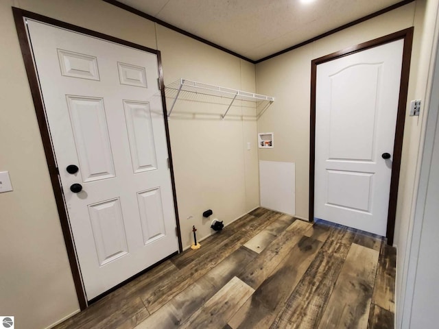 laundry area with gas dryer hookup, dark hardwood / wood-style flooring, washer hookup, crown molding, and a textured ceiling