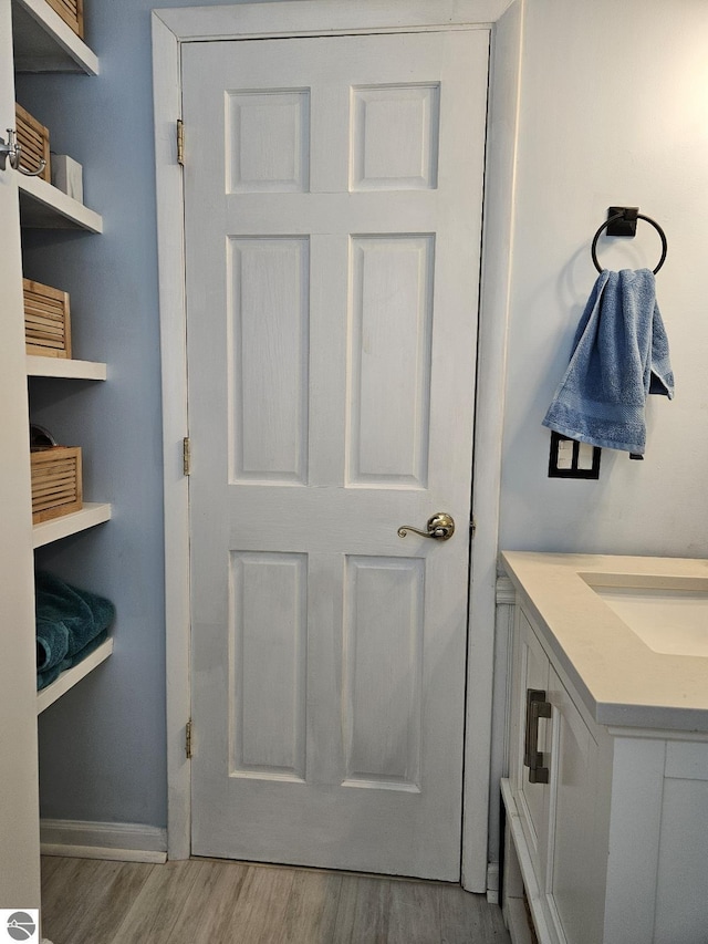 bathroom featuring wood-type flooring and vanity