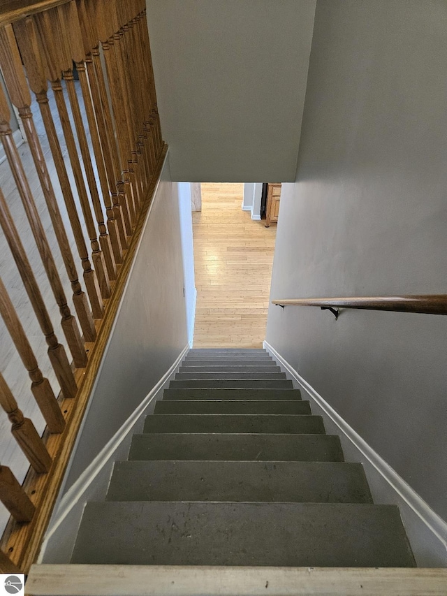 stairs with hardwood / wood-style flooring