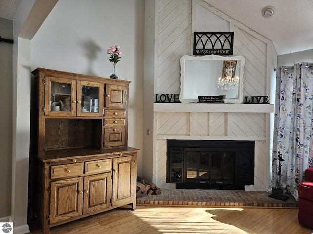 room details featuring wood-type flooring and a brick fireplace