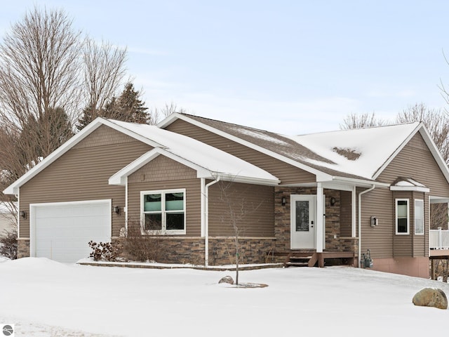 view of front of property featuring a garage and stone siding