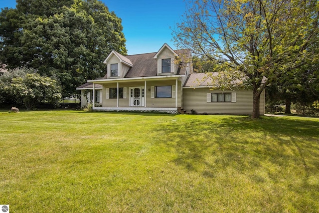 cape cod-style house featuring a front yard and covered porch