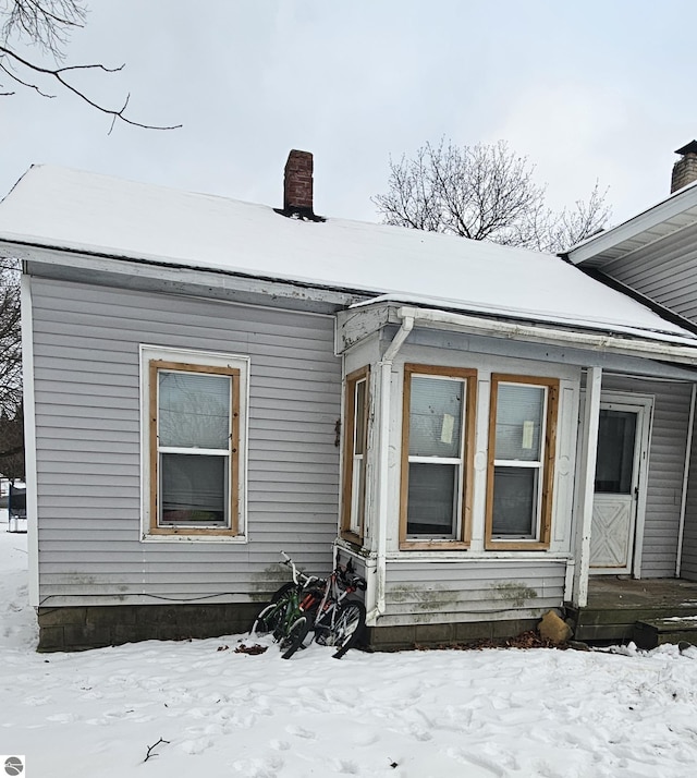 view of snow covered property entrance