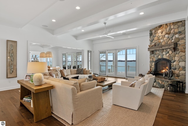 living room featuring a fireplace, french doors, hardwood / wood-style flooring, a water view, and beamed ceiling