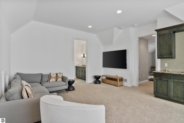 carpeted living room with lofted ceiling