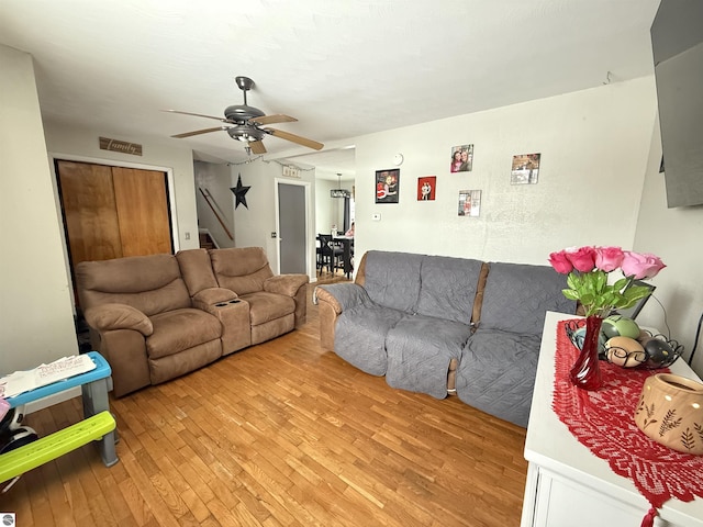 living room featuring ceiling fan and light hardwood / wood-style flooring