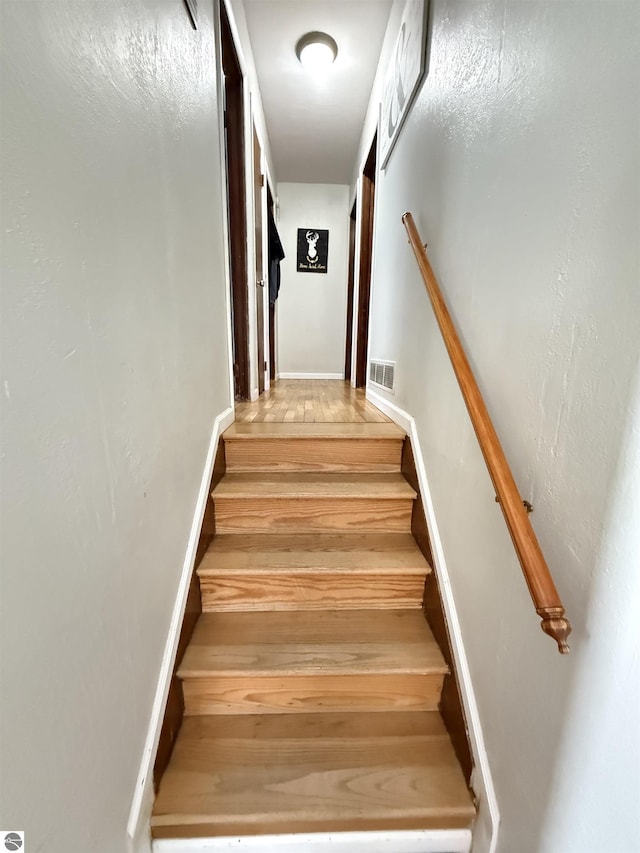 staircase featuring wood-type flooring