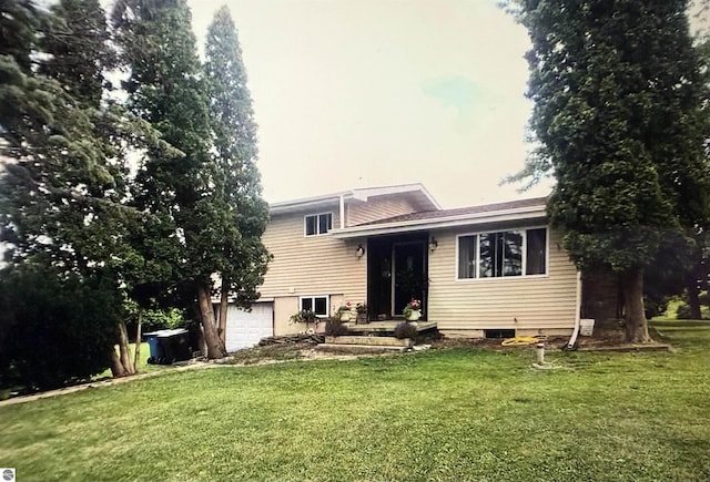 view of front of home featuring a garage and a front lawn