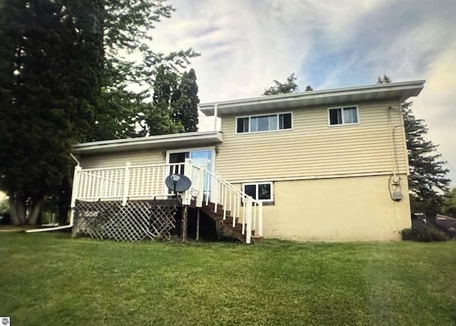 back of house featuring a yard and a deck