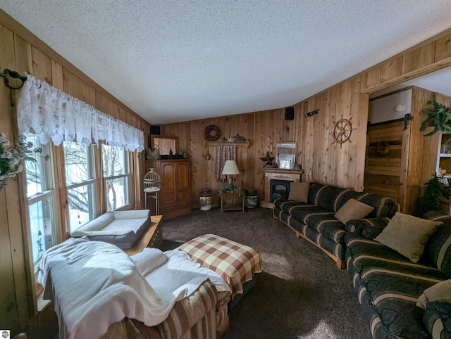 carpeted living room featuring wooden walls and a textured ceiling