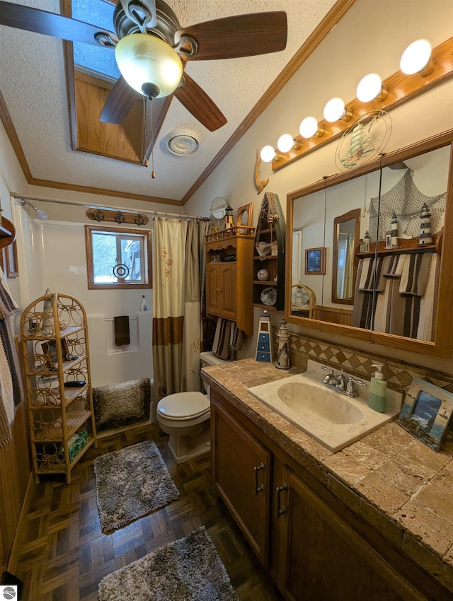 bathroom featuring vanity, ornamental molding, a textured ceiling, parquet floors, and vaulted ceiling