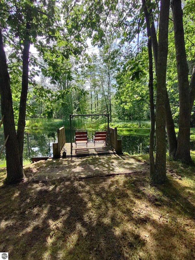 view of property's community featuring a water view and a boat dock