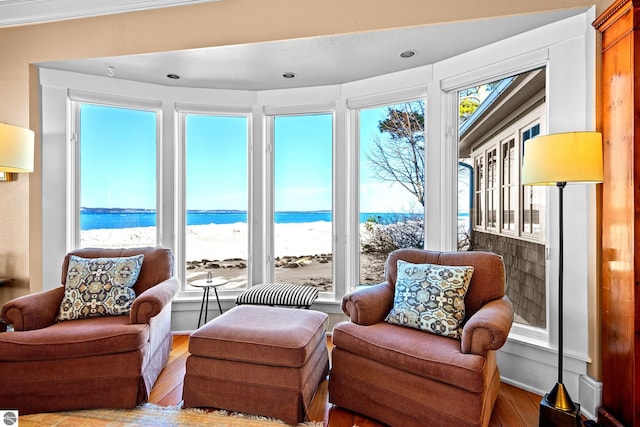 interior space with a water view and a beach view