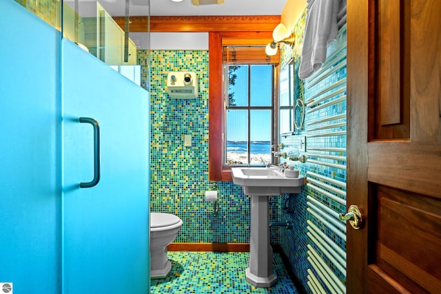 bathroom with tile walls and toilet