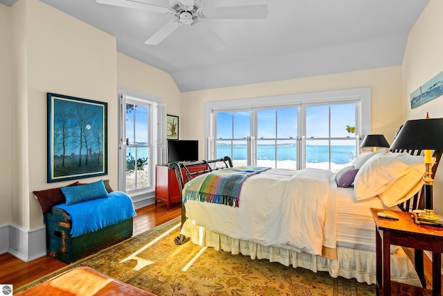 bedroom with vaulted ceiling, access to outside, hardwood / wood-style floors, and ceiling fan