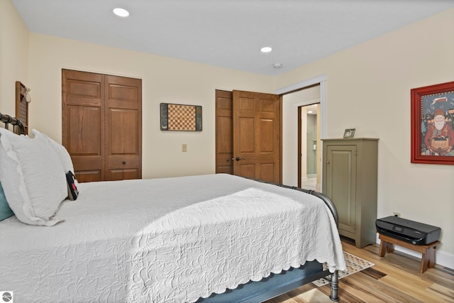 bedroom with a closet and light hardwood / wood-style floors