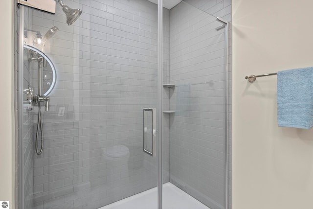 bathroom with a shower with door