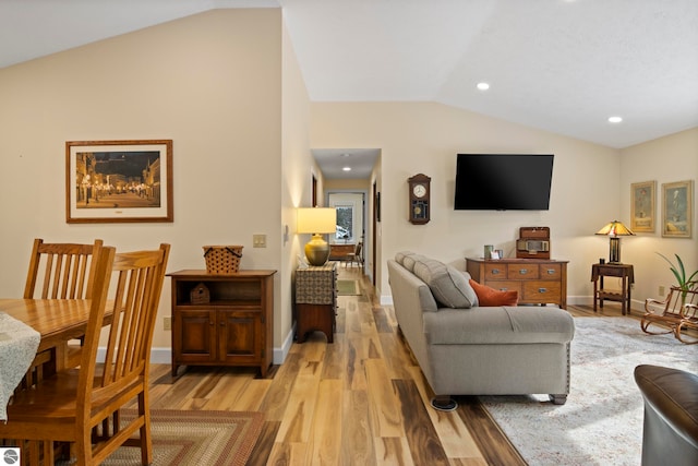 living room with lofted ceiling and light hardwood / wood-style flooring