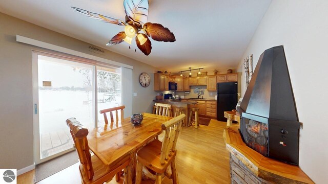 dining room with a ceiling fan, visible vents, and light wood-type flooring