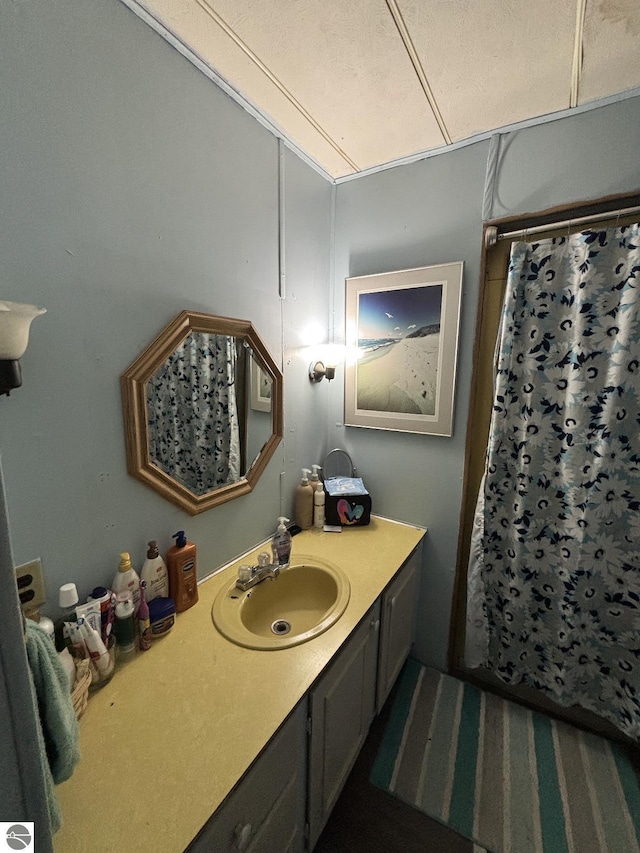 bathroom featuring vanity and a shower with shower curtain