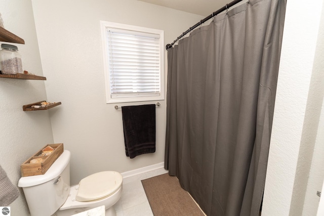 bathroom featuring tile patterned floors and toilet