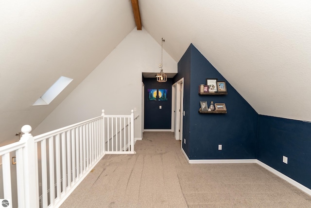 additional living space with vaulted ceiling with skylight and carpet floors