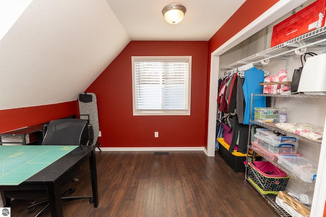 bedroom featuring vaulted ceiling and dark hardwood / wood-style flooring