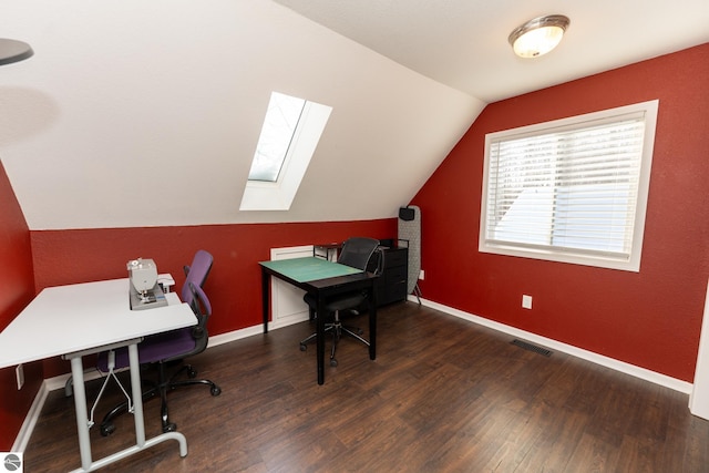 office featuring vaulted ceiling with skylight and dark hardwood / wood-style floors