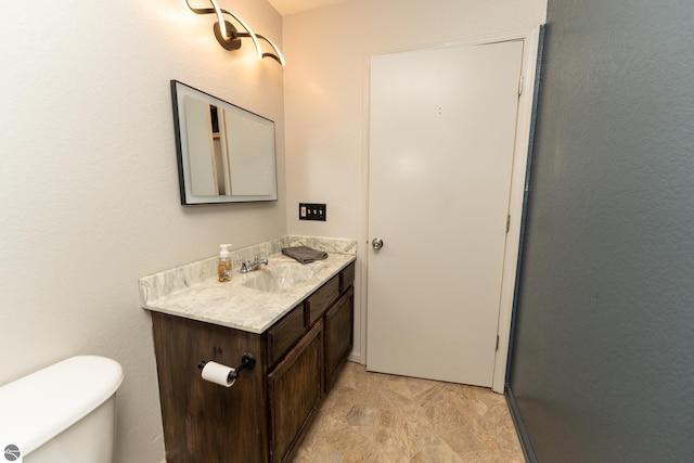 bathroom with toilet and vanity