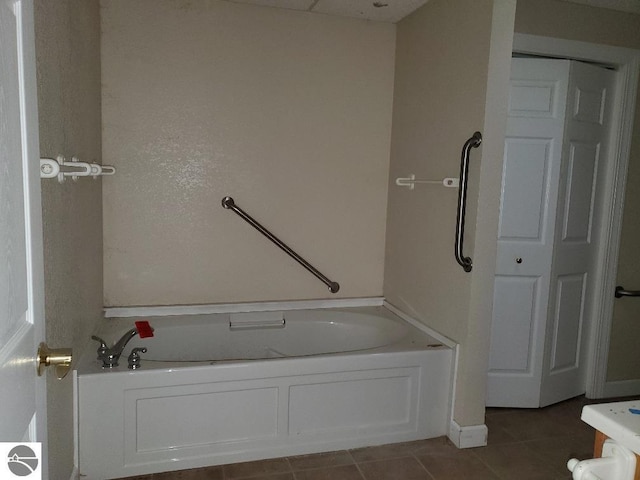 bathroom featuring tile patterned flooring and a bath