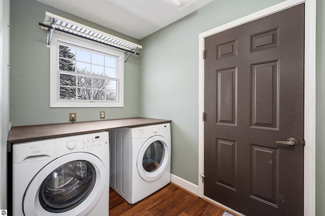 washroom with dark hardwood / wood-style flooring and washing machine and clothes dryer