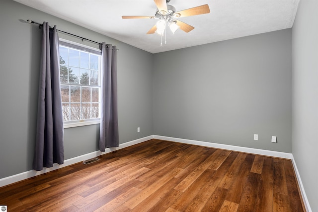 spare room featuring hardwood / wood-style flooring and ceiling fan